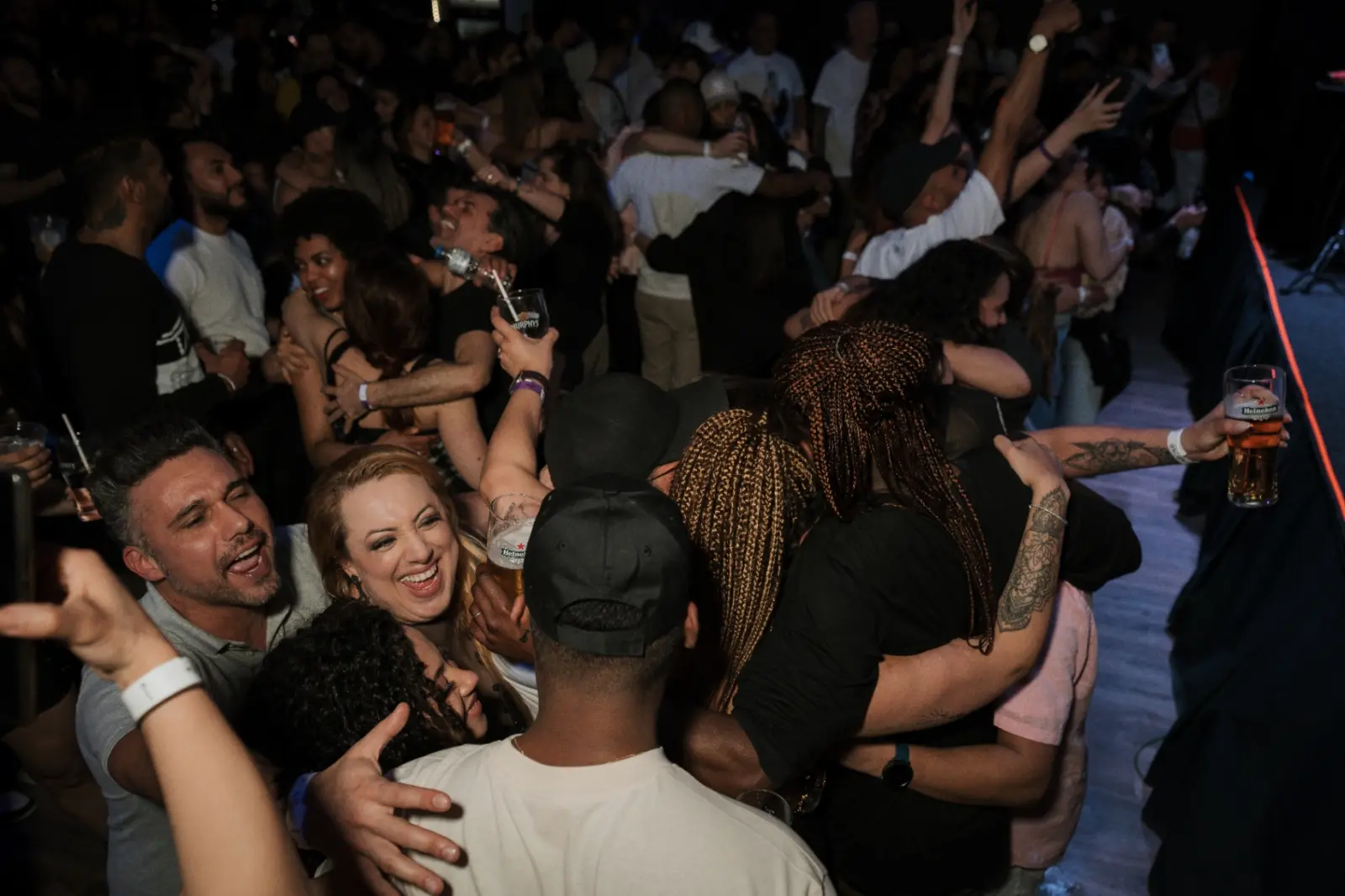 Friends hugging during a show at Kino Events House