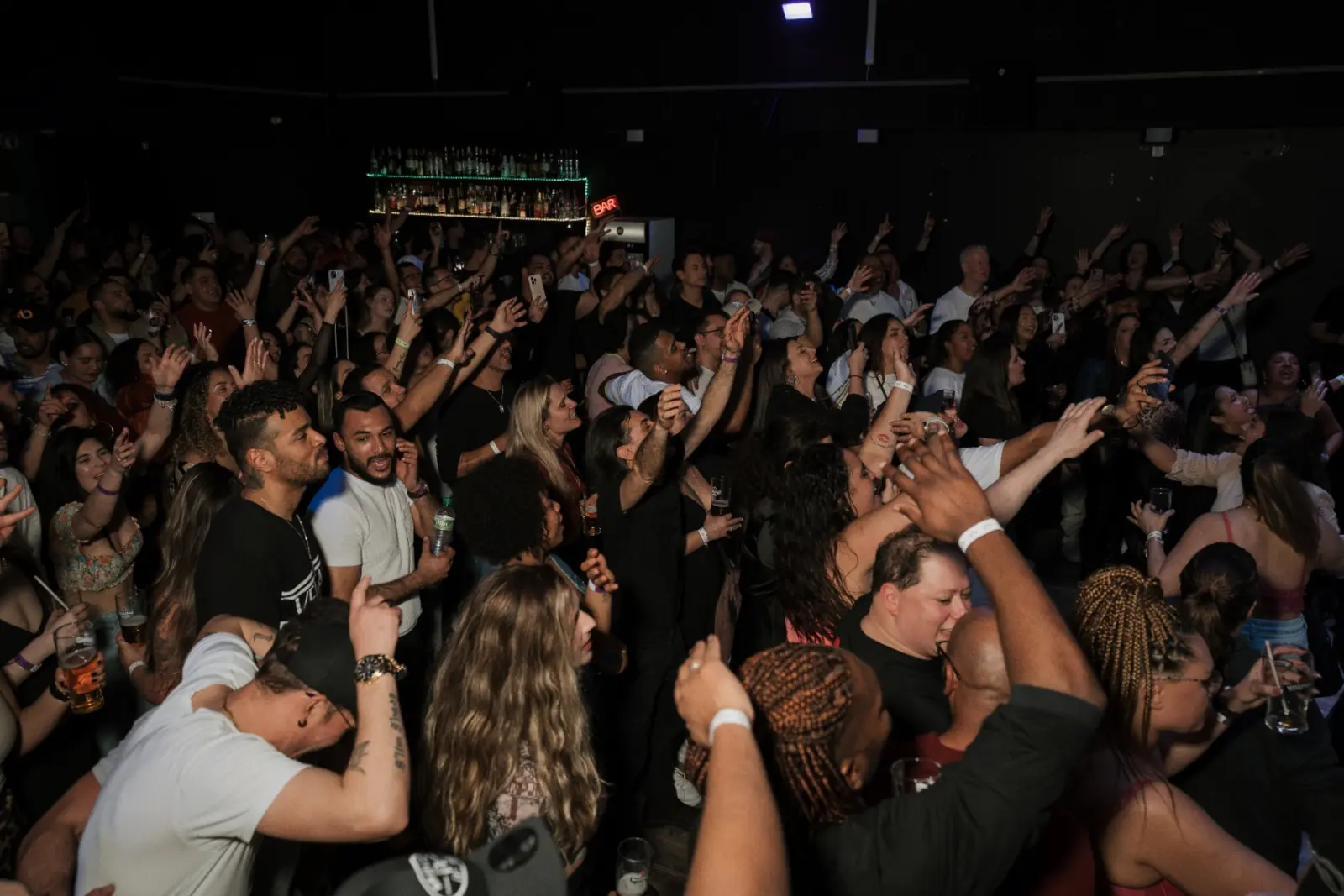 Crowd with hands raised at Kino Events House