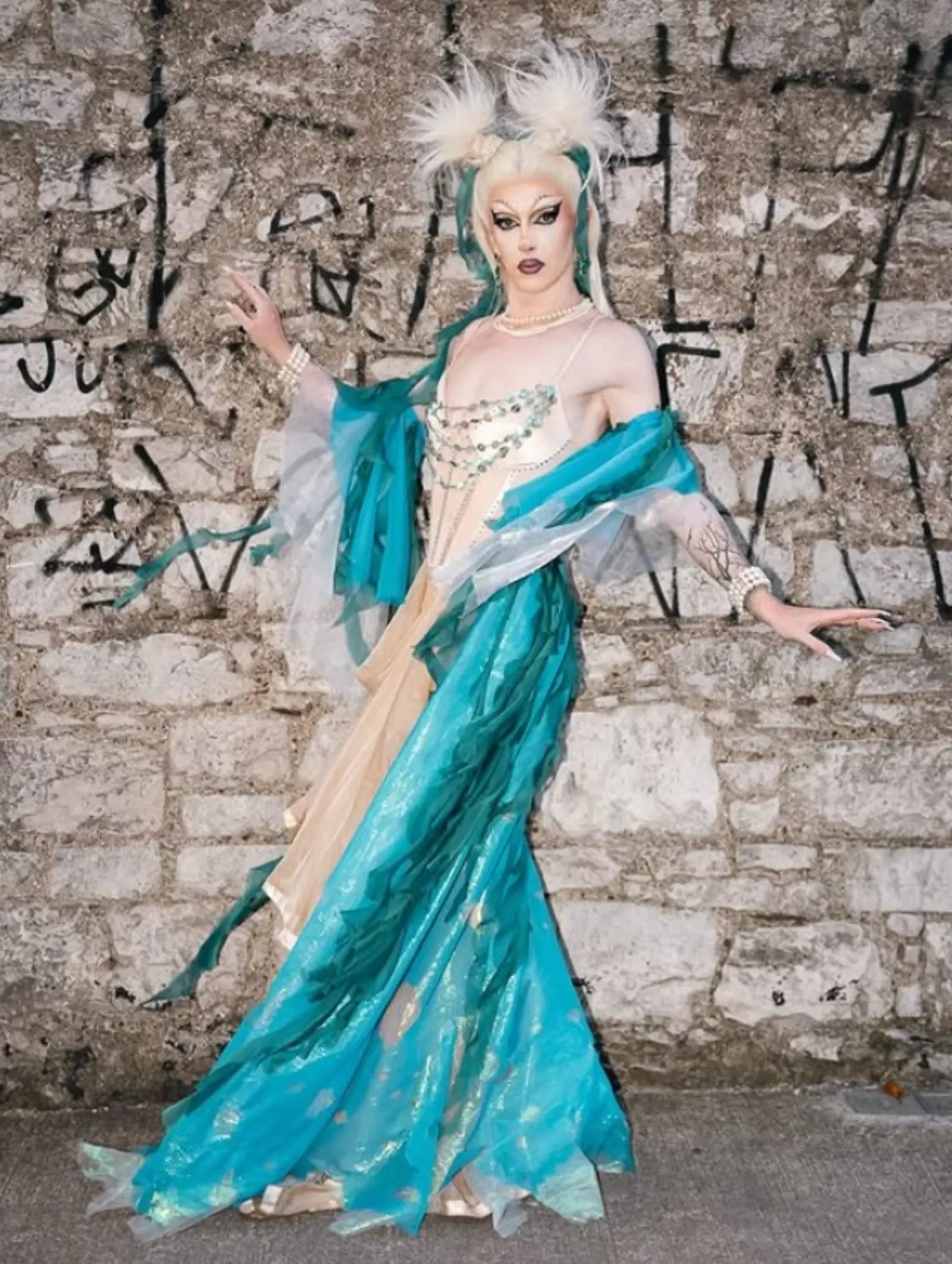Drag performer in teal gown at Kino Events House